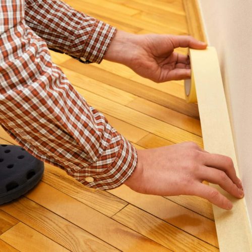Apply painter's tape to baseboard
