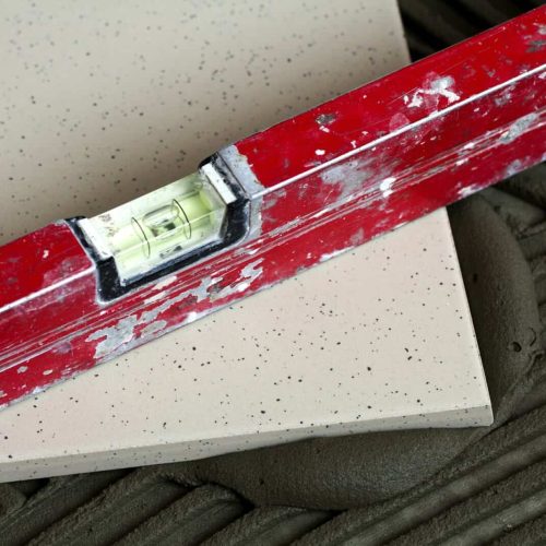 Ceramic tiles and tools for tiler. Floor tiles installation.