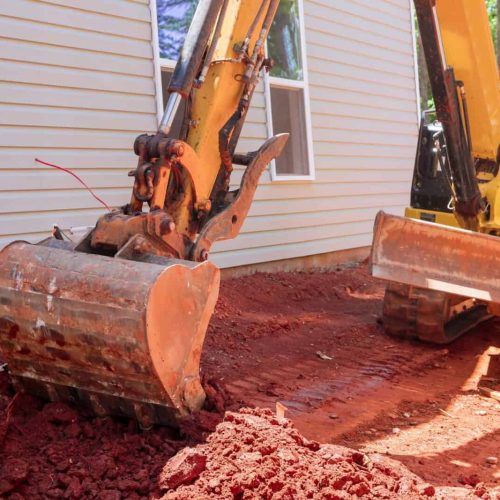 Excavator doing moving soil construction works landscaping works on construction