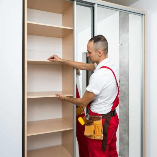 professional furniture maker carpenter makes wardrobe