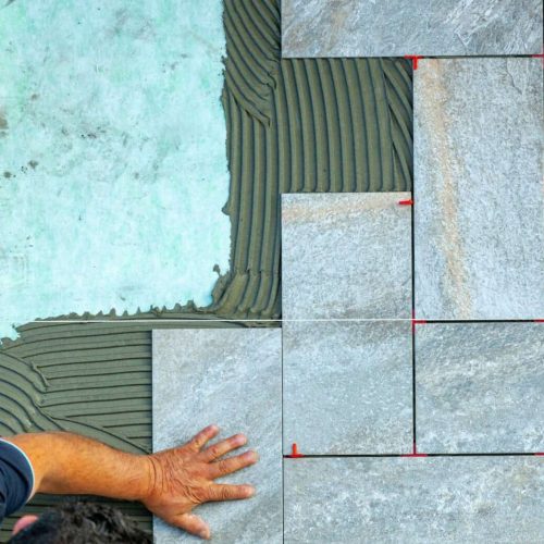 Top view of a tiler working in a garden.