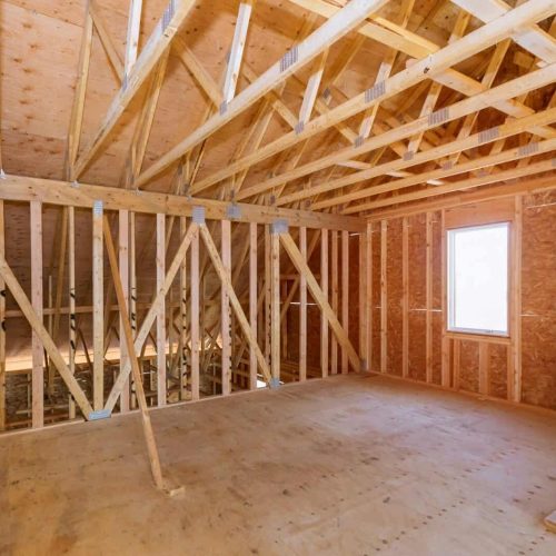 Unfinished attic of a private house residential construction house framing agains